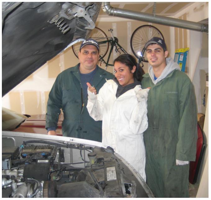 Rocio, my Dad and I working on my truck.