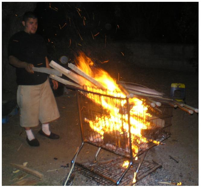 The shopping cart wasn't the best idea because the fire would be too hot and it would shoot off pieces of burning wood.